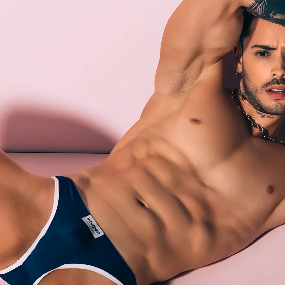 Navy blue Intymen INI035 bikini brief with white trim and small branded label on the waistband for men