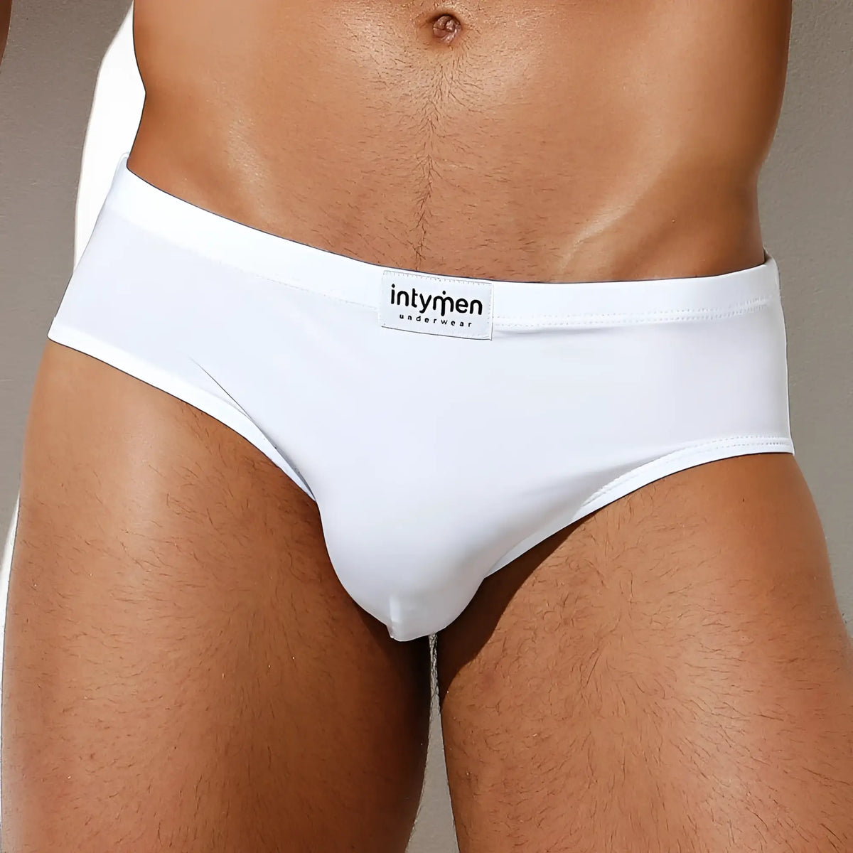 White menâ€™s Intymen INJ065 brief with smooth, form-fitting fabric and branded waistband label visible