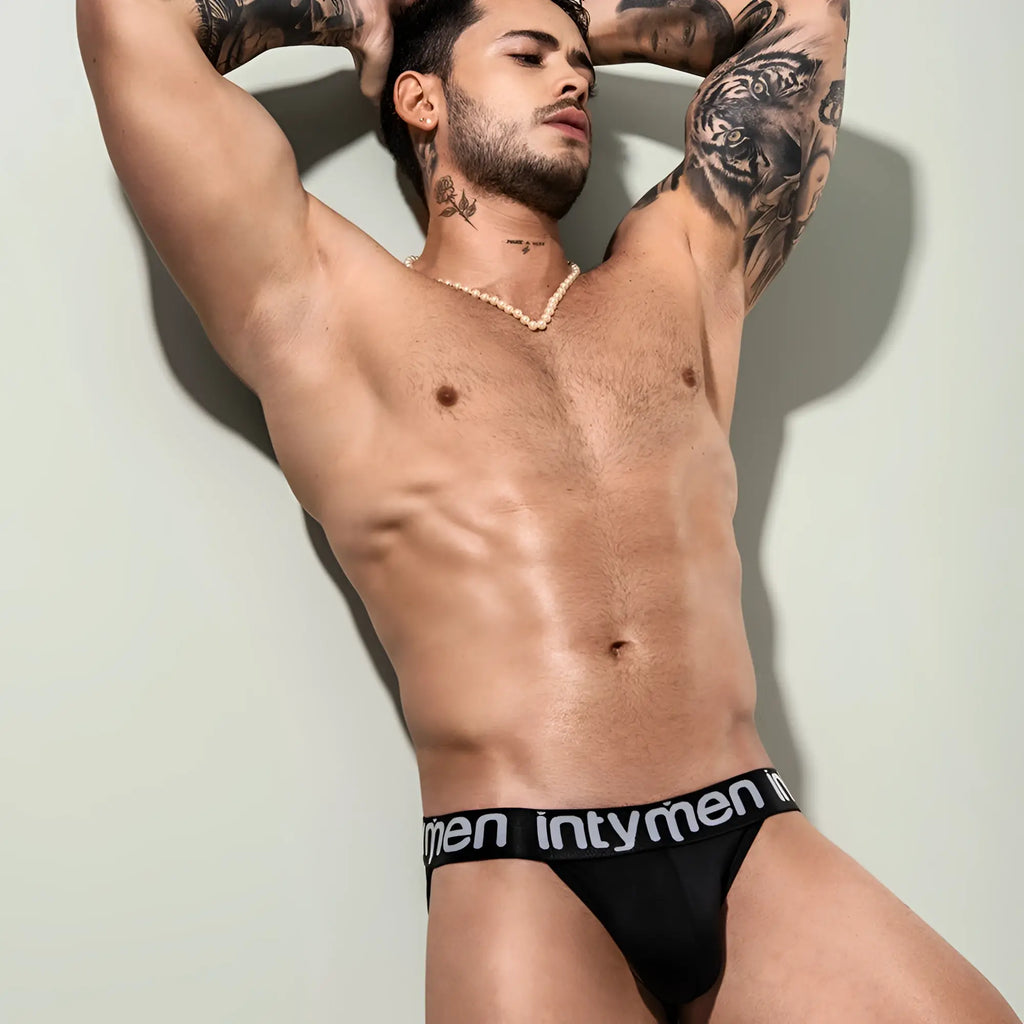 Black briefs with a black elastic waistband featuring white intymen text from the intymen inj079 brief collection
