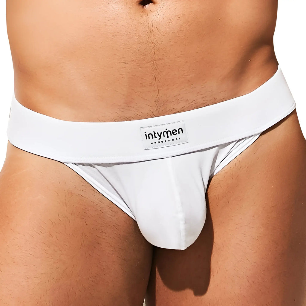 White Intymen INK013 thong with smooth form-fitting design and branded waistband label visible from the front