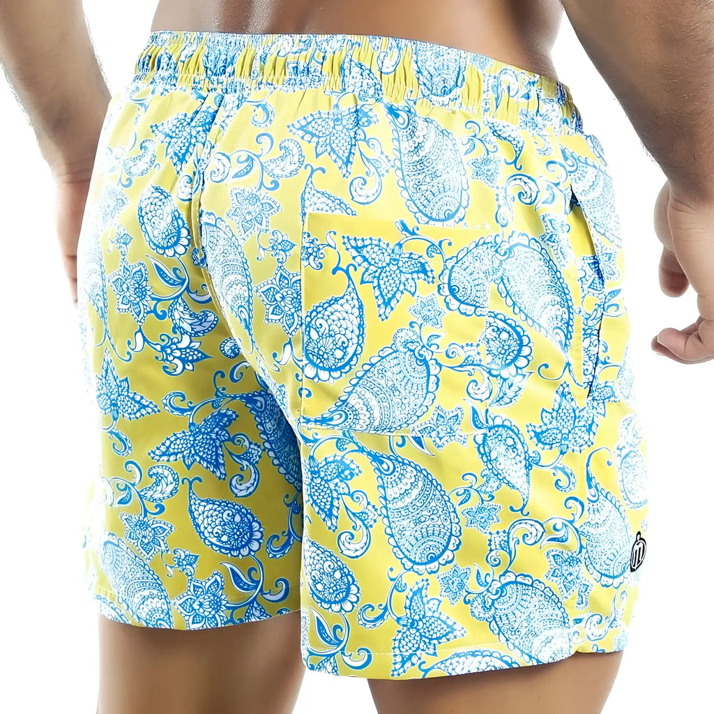 Bright yellow Intymen INO011 swim trunks with intricate blue and white paisley pattern for beachwear