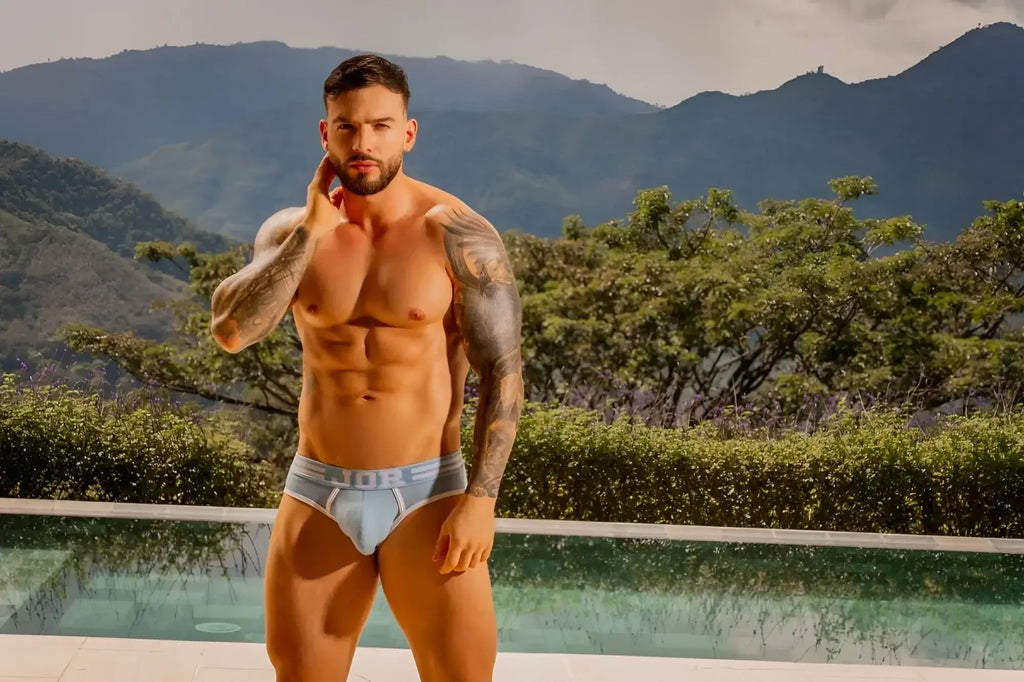 JOR 2321 College Briefs in blue, worn by a model in a front-view lifestyle shot by a pool.