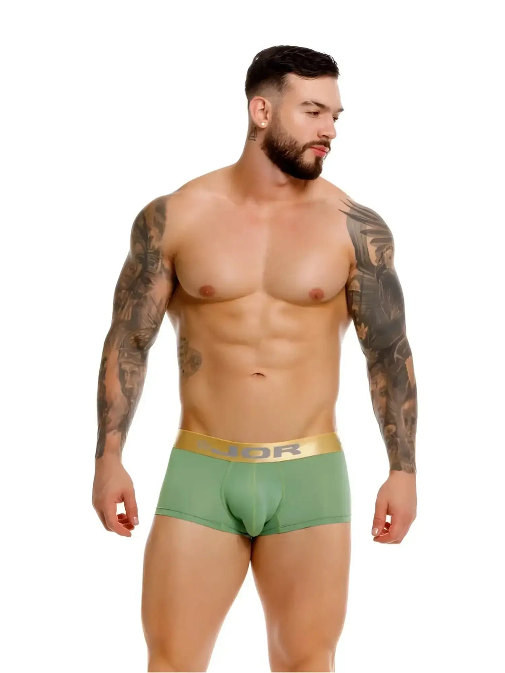 Front view of a model wearing green JOR 2326 Soho trunks with a gold waistband.