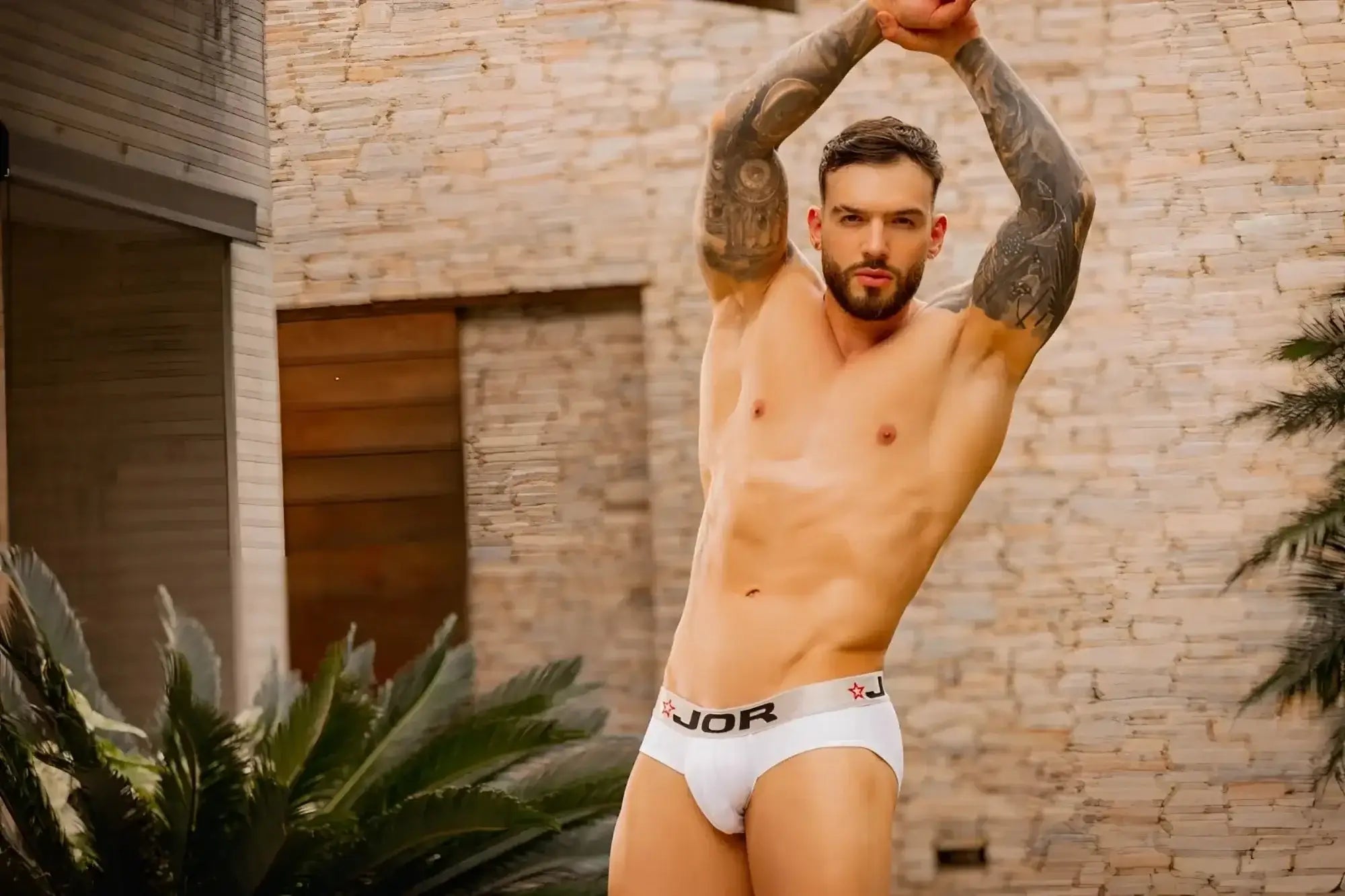 Lifestyle shot of a man wearing JOR 2331 Cronos white briefs.