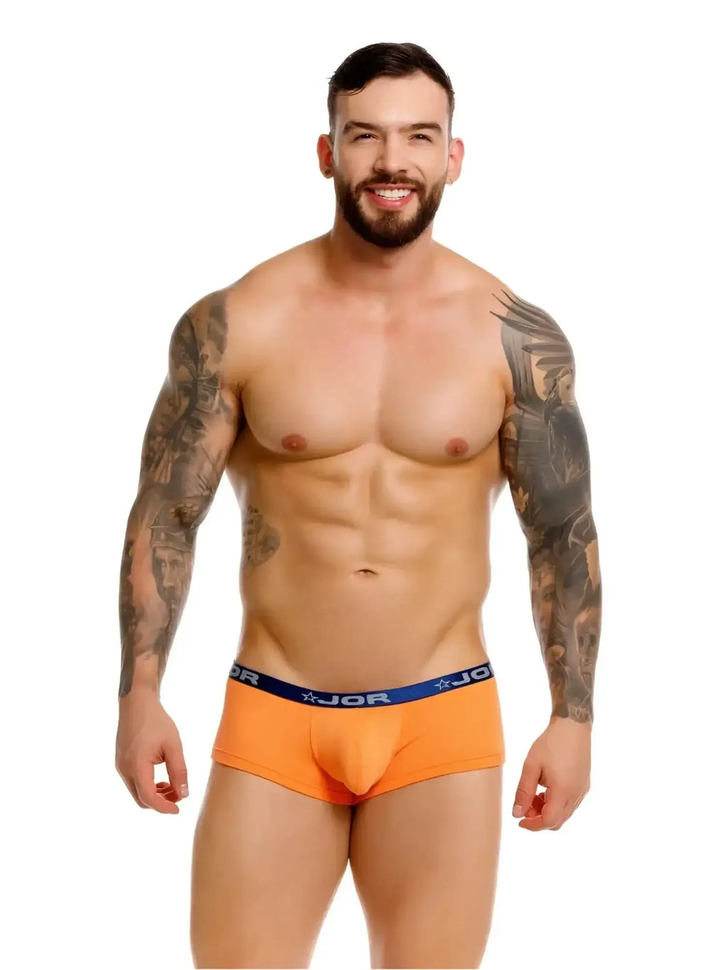 Front view of a model wearing JOR 2345 Cannes trunks in orange.