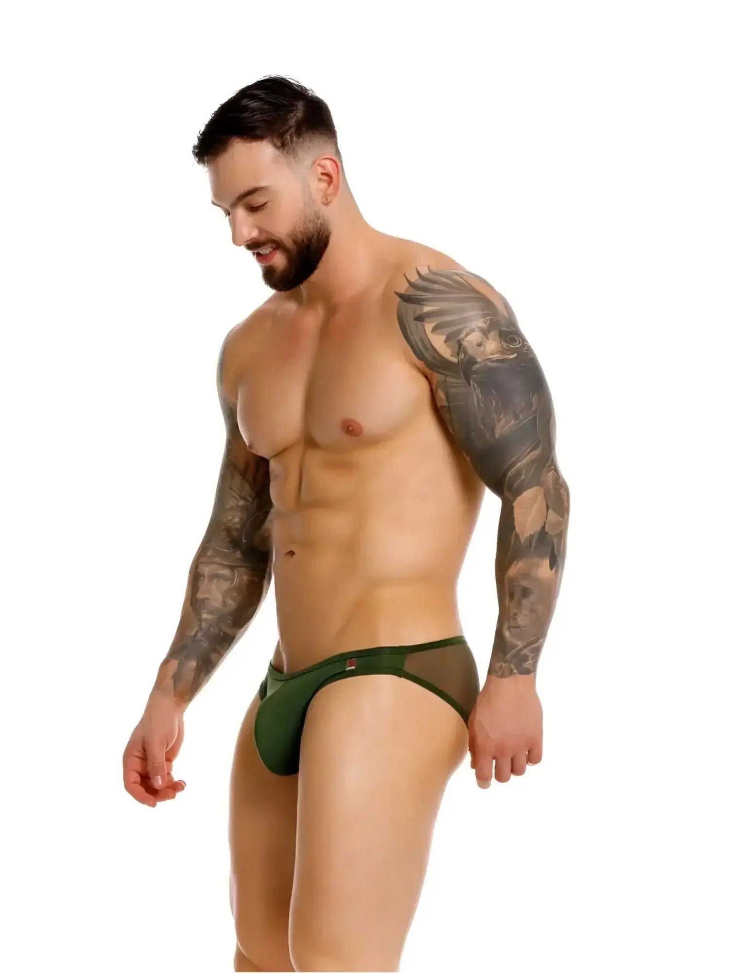 JOR 2353 Origin bikini in green, side view of a tattooed man wearing the underwear against a white background.