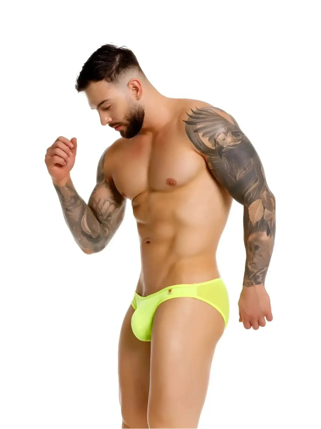 Side view of a muscular man wearing JOR 2353 Origin Bikini in neon green.