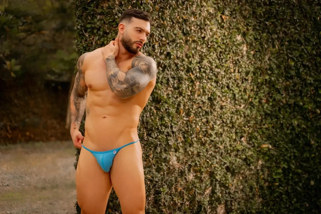 Lifestyle shot of a man wearing JOR 2358 Axel bikini in turquoise.