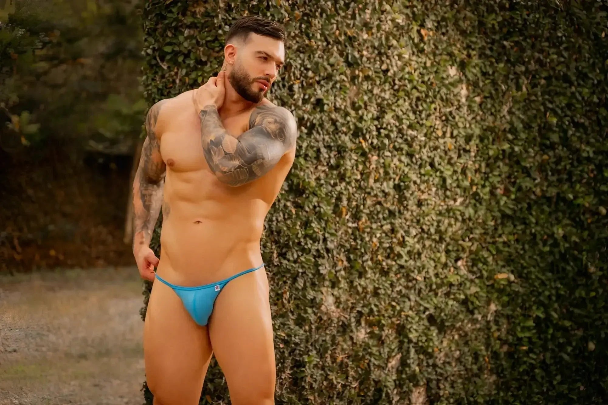 Lifestyle shot of a man wearing JOR 2358 Axel bikini in turquoise.