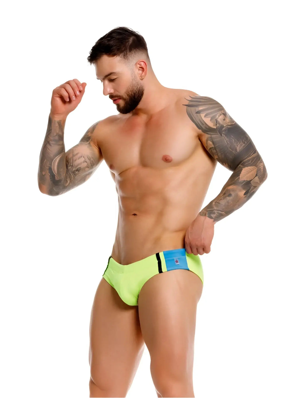 Model wearing JOR 2384 Wind green swim briefs in a side-profile lifestyle shot.