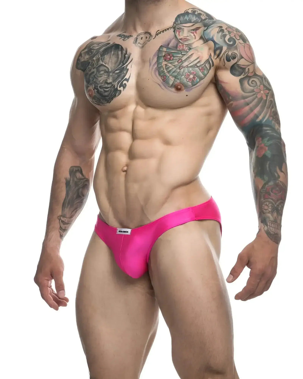 Bright pink justin+simon classic bikini briefs with form-fitting design and small white brand tag at waistband