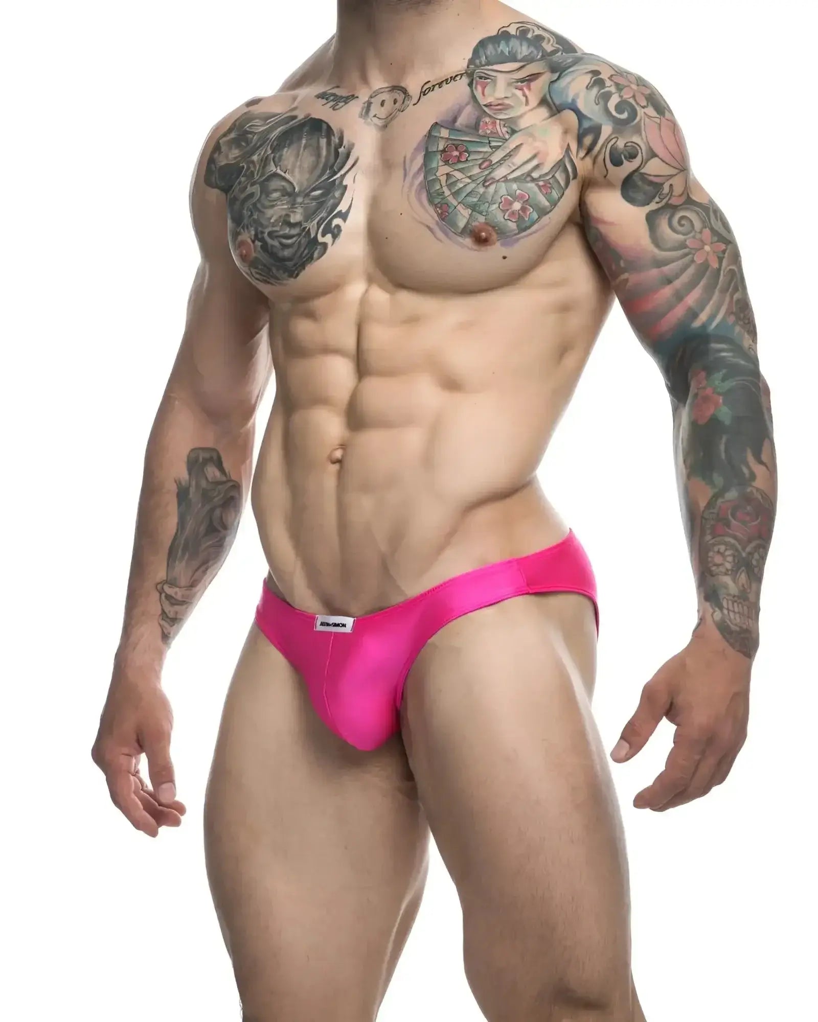 Bright pink justin+simon classic bikini briefs with form-fitting design and small white brand tag at waistband