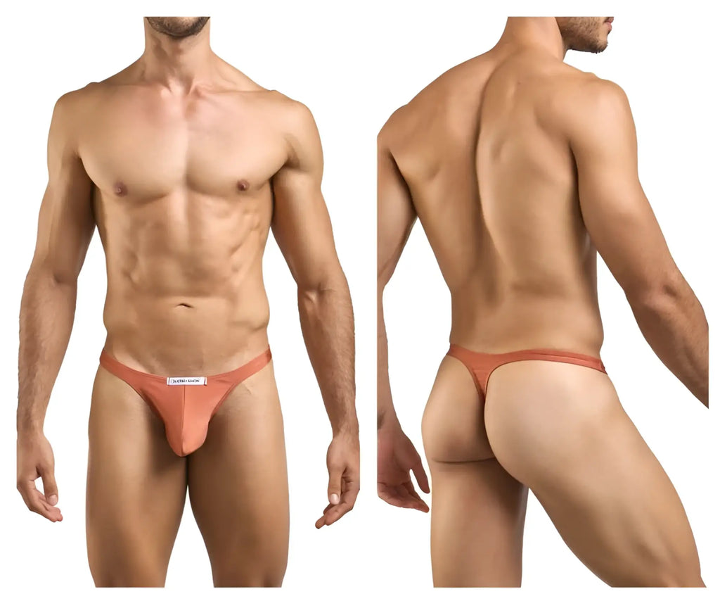 A sleek peach-colored justin simon xsj03 classic thong made of smooth fabric with a minimalist design and white label