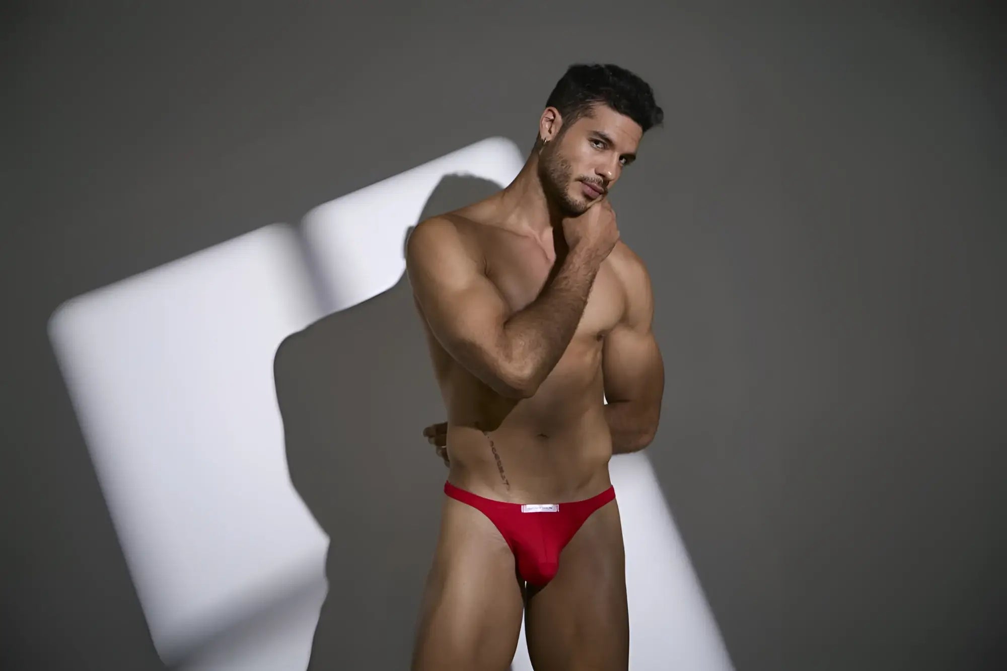 Justin simon classic men’s red briefs with a white logo on the front in peach red color