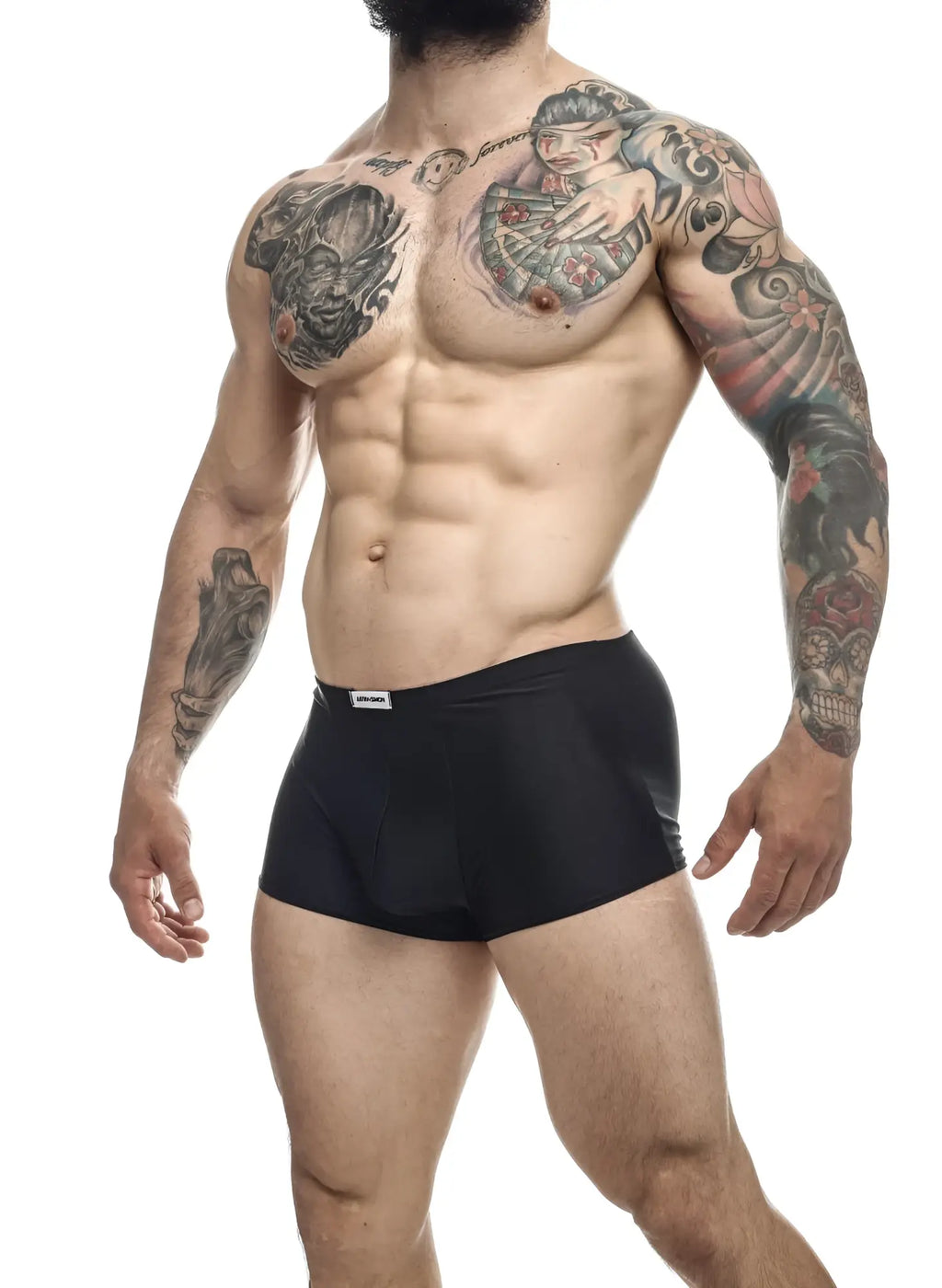 Black justin simon xsj08 classic trunks featuring a small white brand tag on the waistband for athletic use