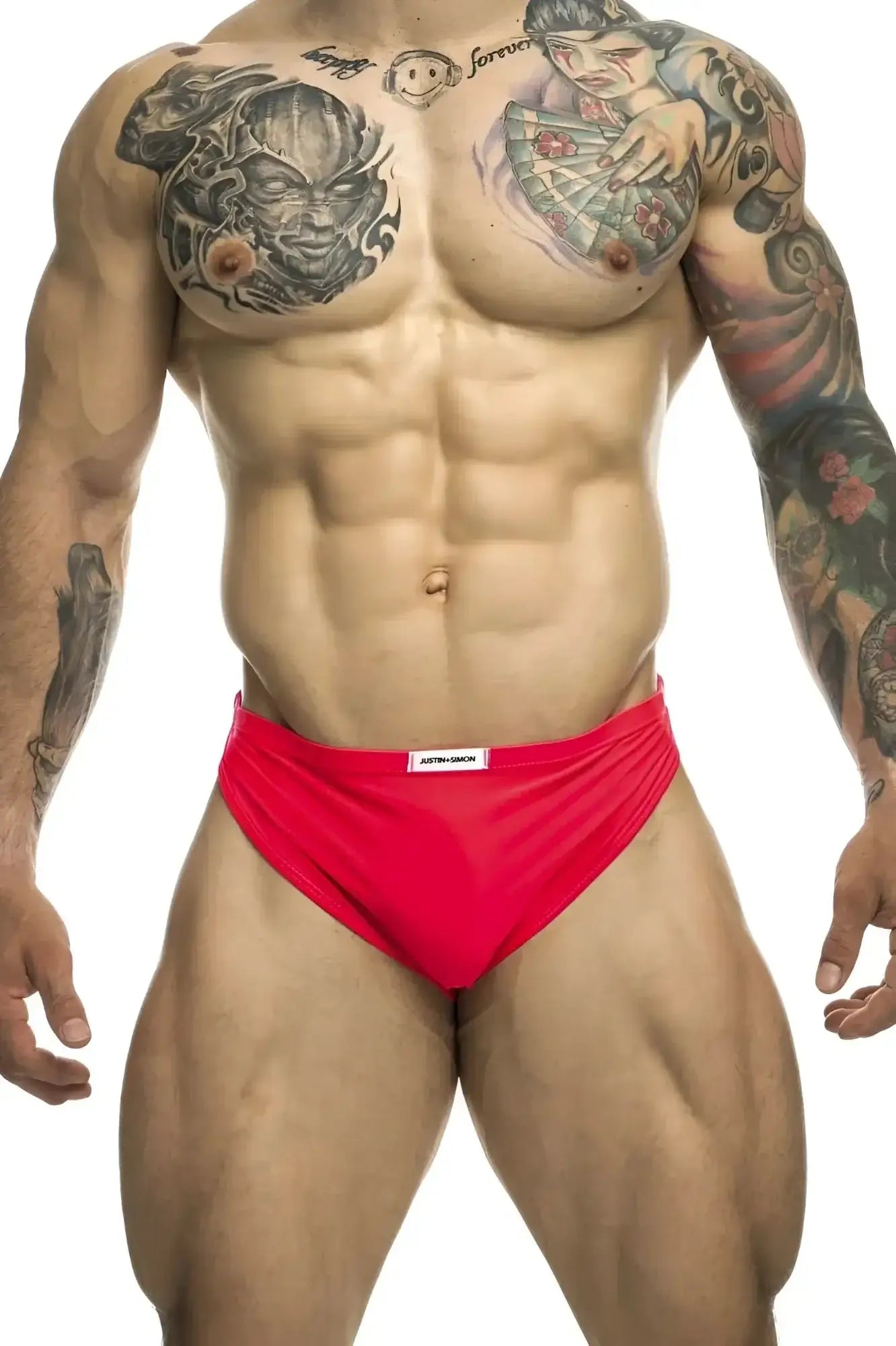 Bright red form-fitting coral running briefs with a white justin+simon brand tag on the waistband
