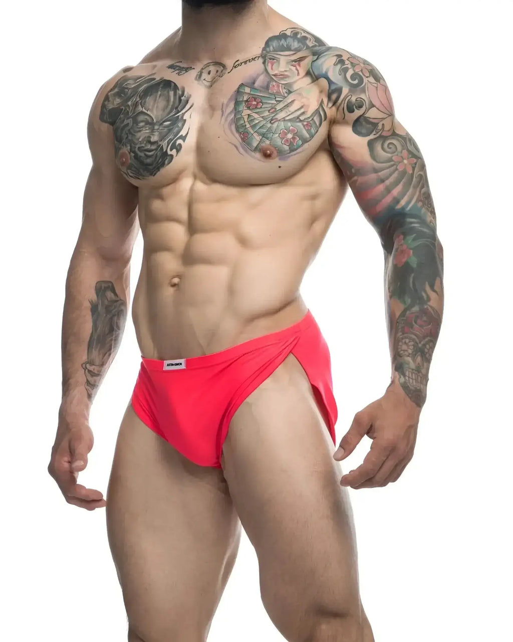 Bright red form-fitting swim trunks with a small white brand tag on the waistband from justin simon xsj09 coral collection