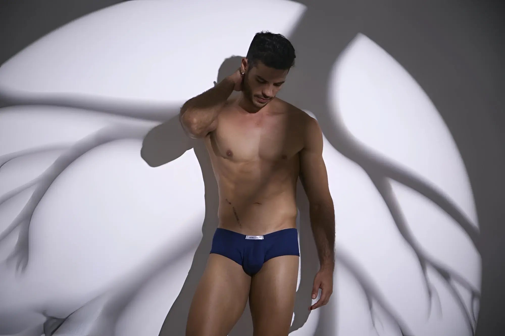 Navy blue cheeky bulge boxer briefs with a small white logo on the waistband by JUSTIN+SIMON