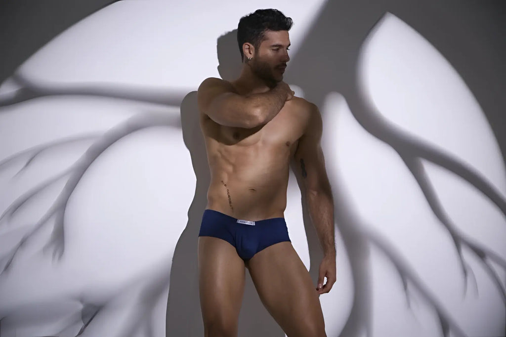 Navy blue cheeky bulge boxer briefs with white logo waistband from JUSTIN+SIMON XSJ13 in peach and navy colors