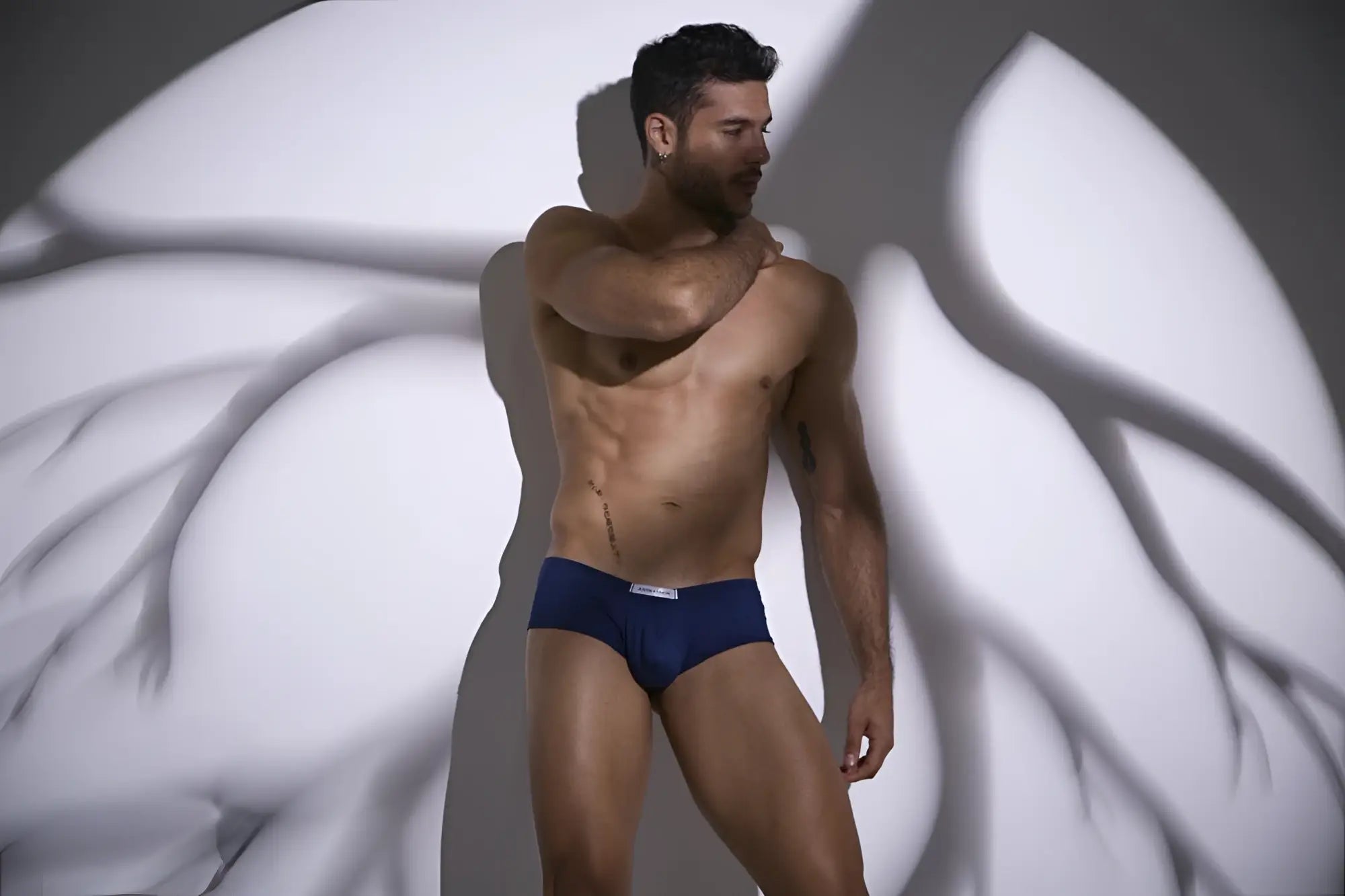 Navy blue cheeky bulge boxer briefs with white logo waistband from JUSTIN+SIMON XSJ13 in peach and navy colors