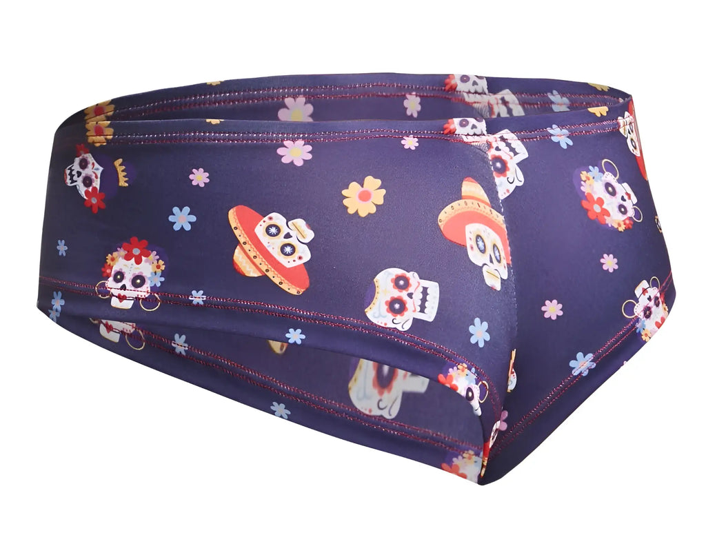 Dark blue men’s briefs with vibrant day of the dead sugar skulls colorful flowers and sombreros design by justin+simon