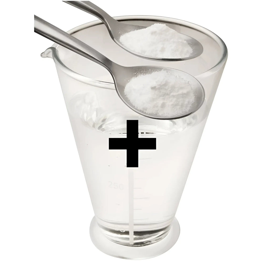 Clear glass measuring cup filled with water and two silver spoons holding white k lube powder 200gm for 20 litres use