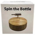 Silver metallic bottle-shaped spinner on a circular wooden base for kheper games spin the bottle game
