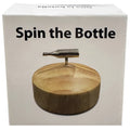 Silver metallic bottle-shaped spinner on a circular wooden base for kheper games spin the bottle game