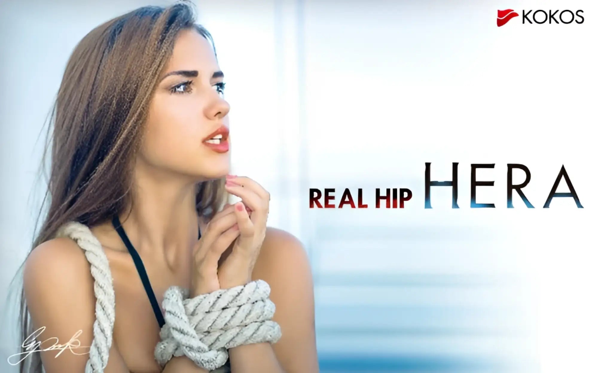 A woman with long brown hair wearing a black top with thick light gray rope tied around her wrists for Kokos Real Hip Hera