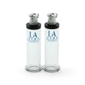 Two transparent glass la pump nipple enlargement cylinders with black caps and silver pump mechanisms 16mm diameter