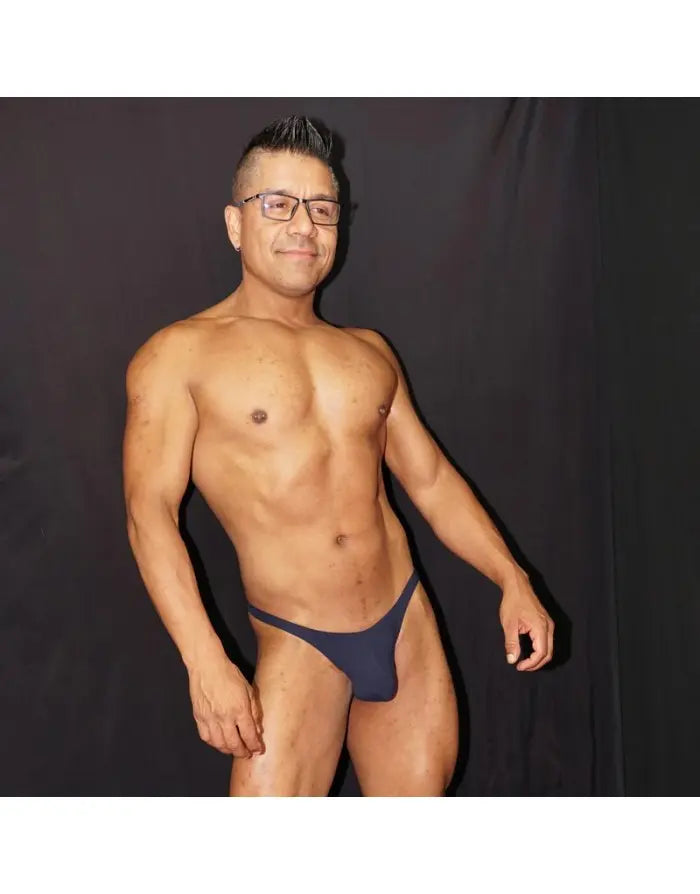 Model wearing navy thong underwear by Arroyman showcasing a minimal design and comfortable fit.