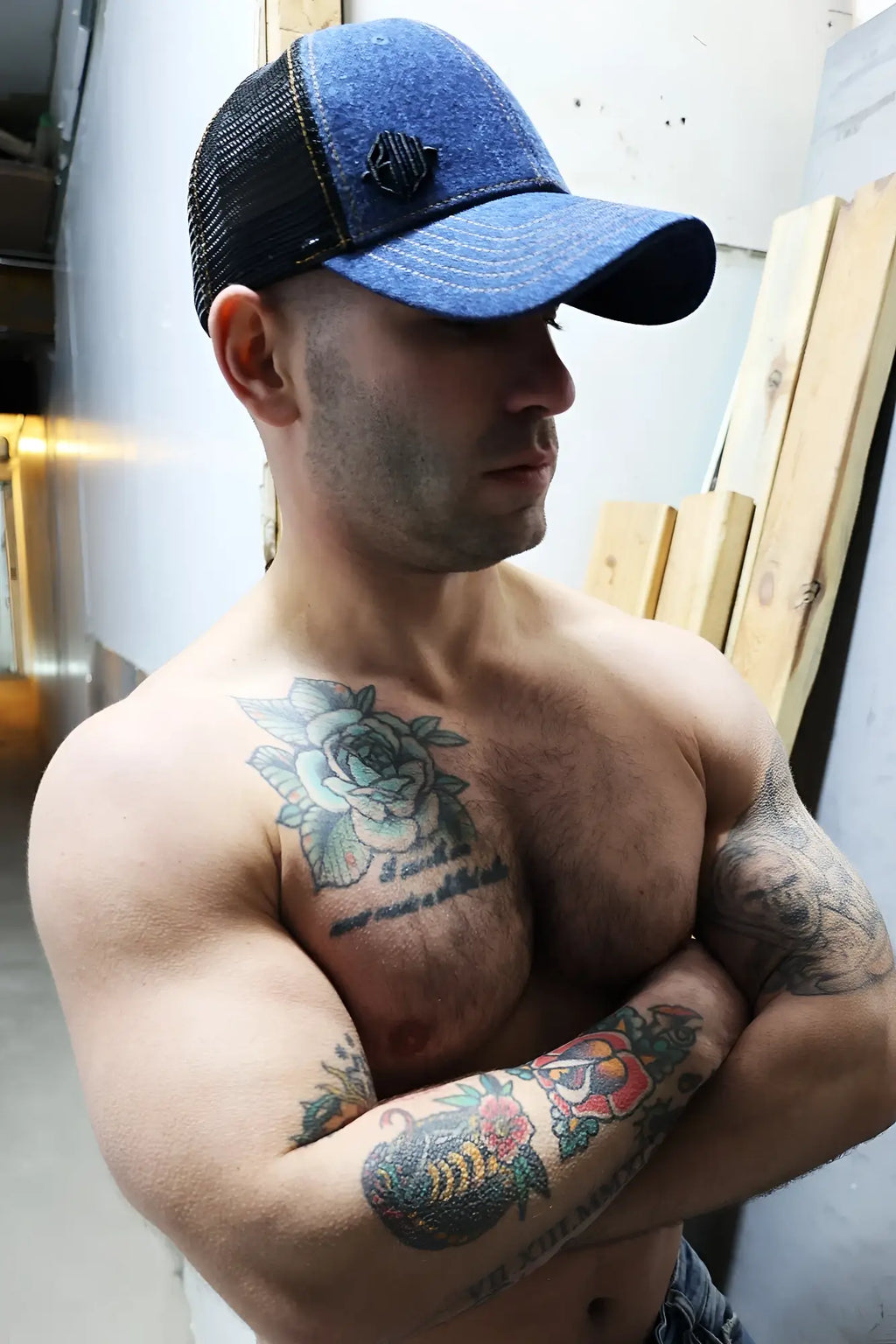 Blue and black denim trucker hat with small embroidered logo on front loaded denim trucker hat style