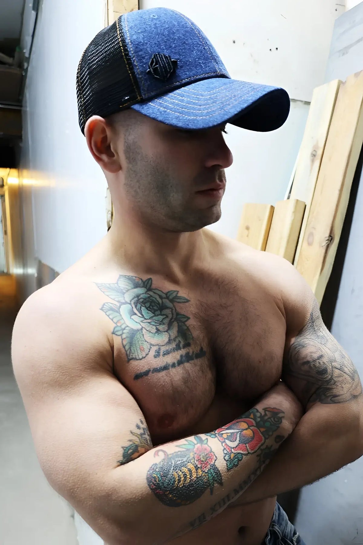 Blue and black denim trucker hat with small embroidered logo on front loaded denim trucker hat style