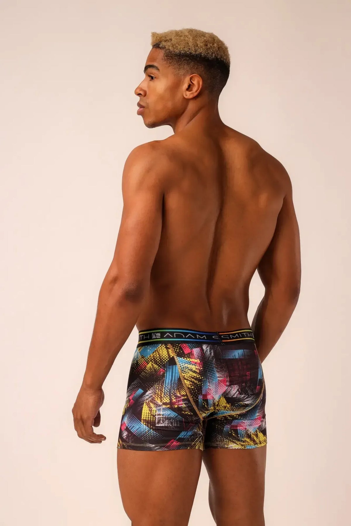 Adam Smith brand long trunks menâs boxer briefs with vibrant abstract geometric pattern in yellow blue pink on dark fabric