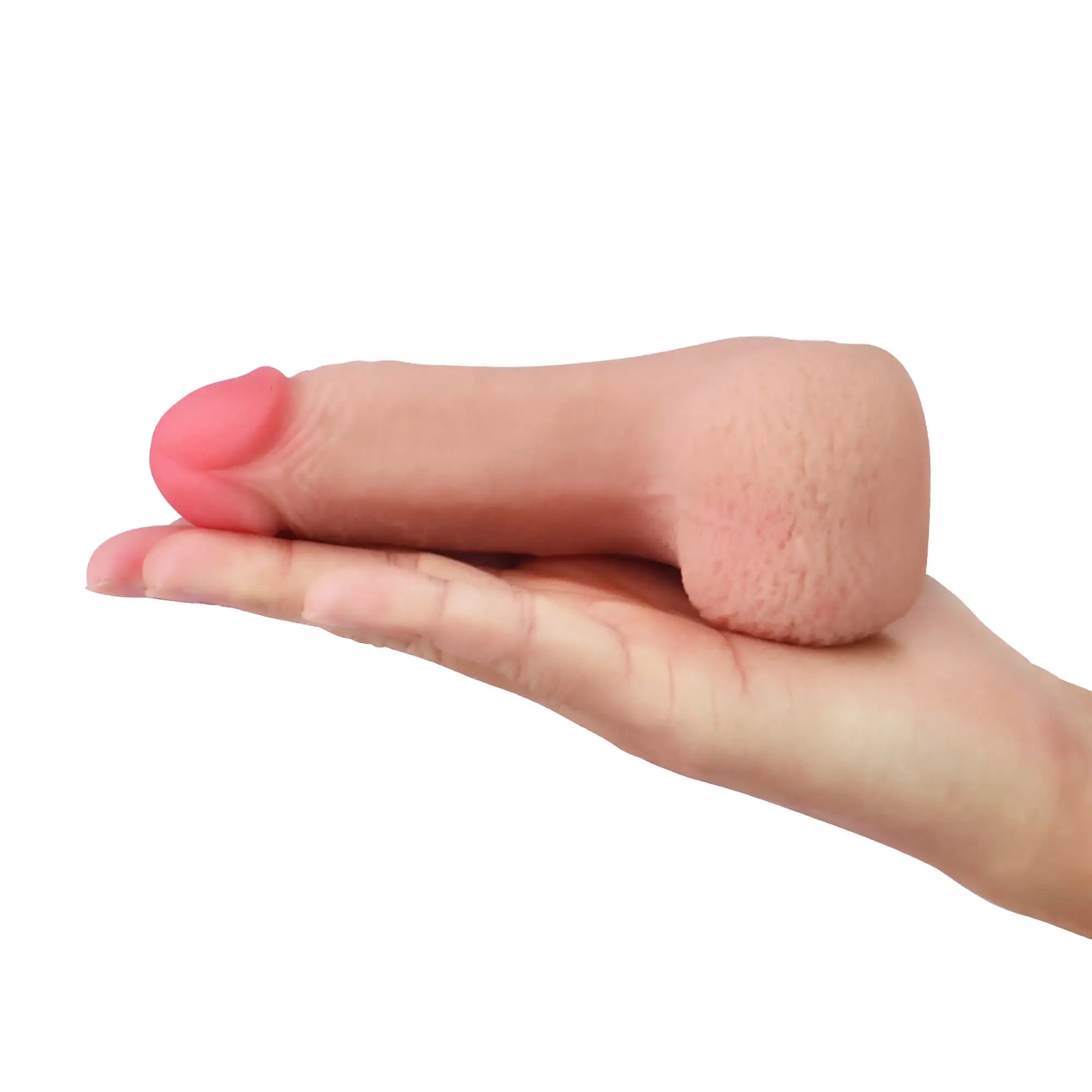 Pink silicone realistic 5 inch male genital lovetoy limpy cock packer held in hand showing front side