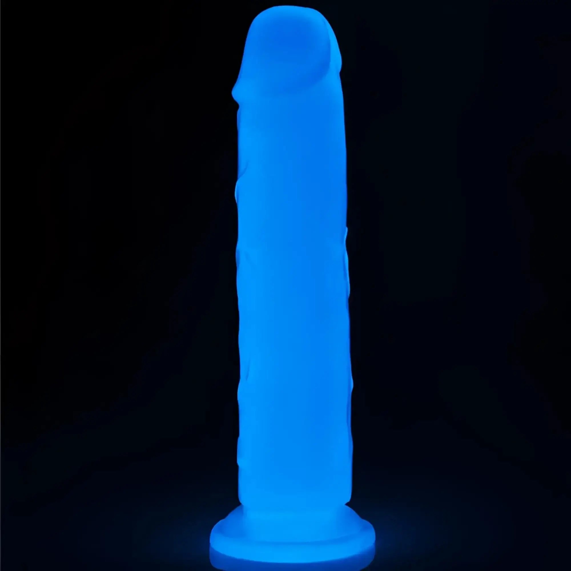 A glowing blue silicone lovetoy lumino play dildo 8in with a textured surface and rounded head