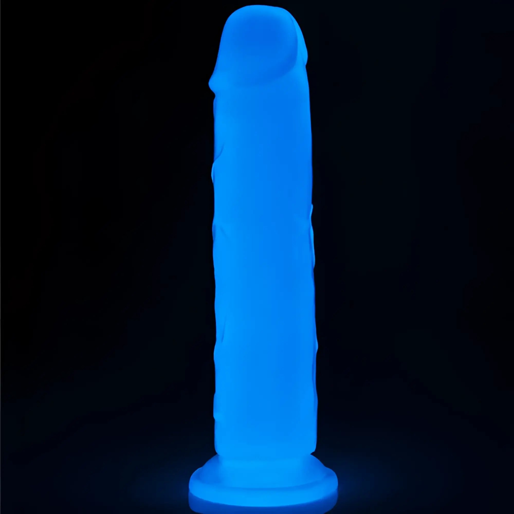 A glowing blue silicone lovetoy lumino play dildo 8in with a textured surface and rounded head