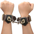Black leather lovetoy rebellion reign handcuffs with gold-tone hardware and a heart and letter e pattern