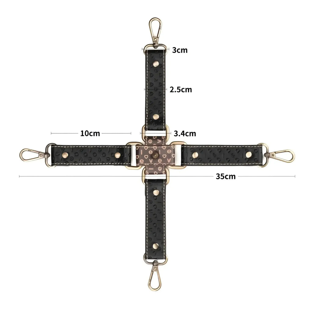 Black leather crossbody strap with embossed lettering and gold-tone hardware for lovetoy rebellion reign hogtie set