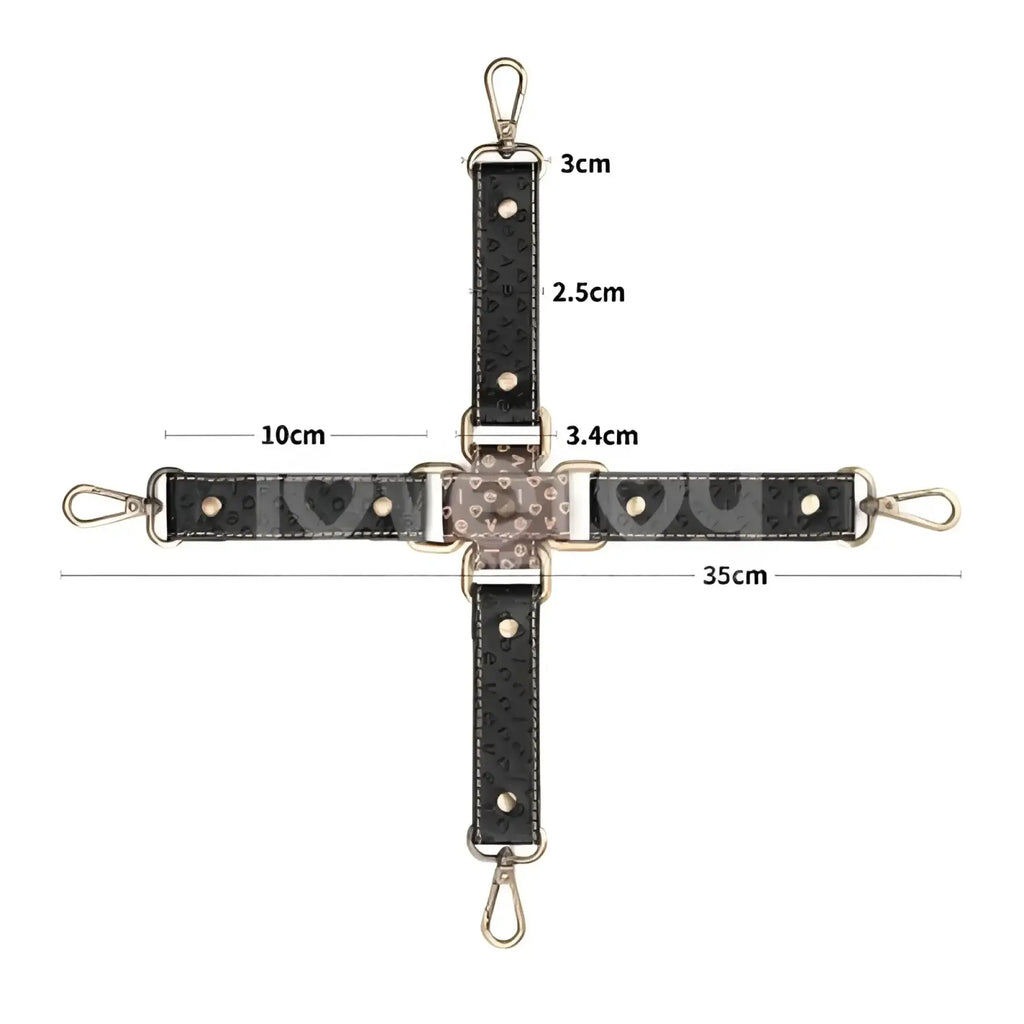 Black textured leather crossbody strap with gold-tone hardware and heart-shaped embellishments.