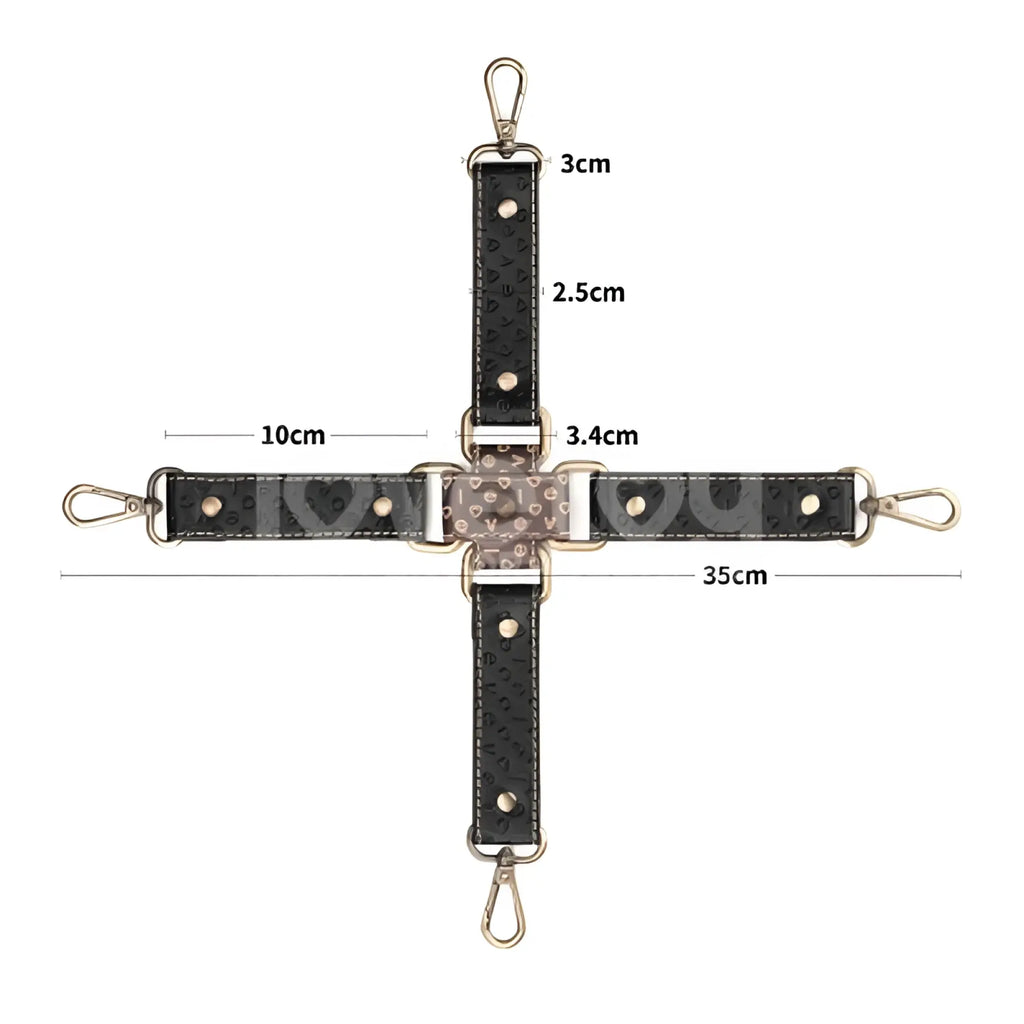 Black textured leather crossbody strap with gold-tone hardware and heart-shaped embellishments for lovetoy rebellion reign hogtie set