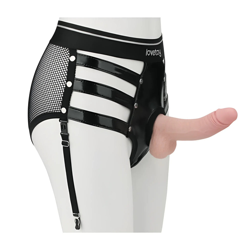 Black latex harness with mesh panels and silver-toned hardware branded lovetoy rebellion reign iconic harness strap on set m/l