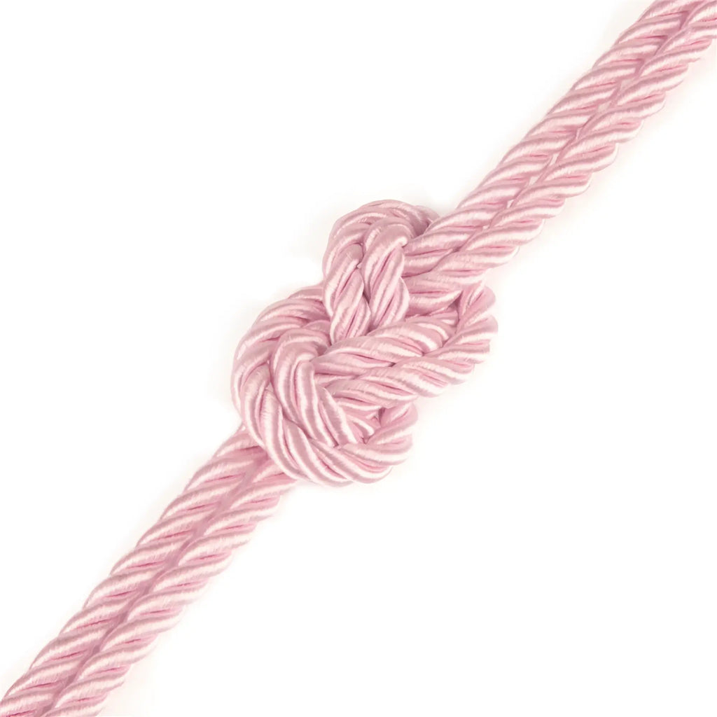 A delicate pink braided silky bondage rope with a neatly tied knot from lovetoy rebellion reign rose 10m