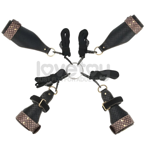 Black leather bondage set with brown studded accents and gold hardware in lovetoy rebellion reign under mattress restraint