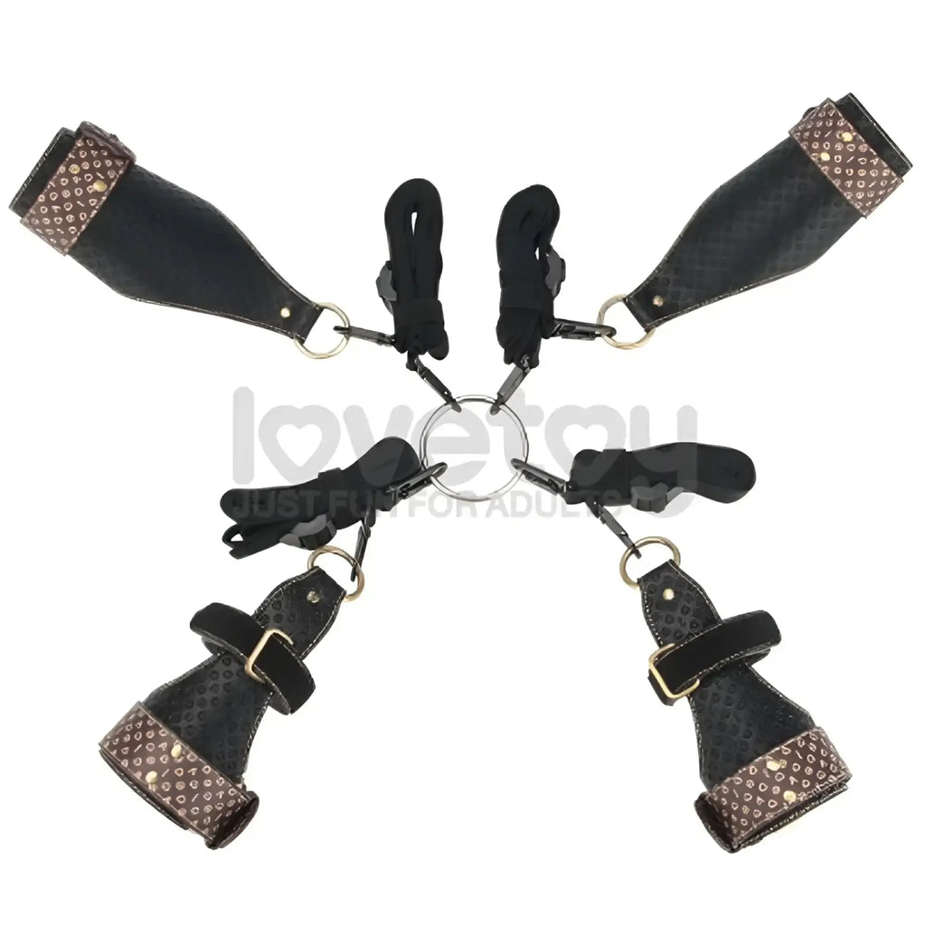 Black leather bondage set with brown studded accents and gold hardware in lovetoy rebellion reign under mattress restraint