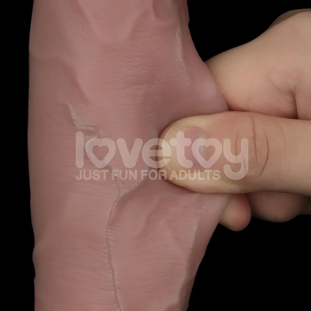 Pink silicone lovetoy sliding skin pro dual layer 10in dong with realistic skin texture and visible seam