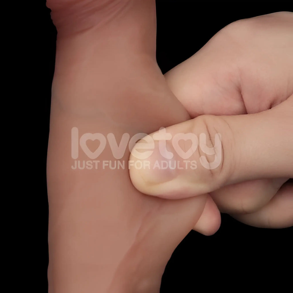 A flesh-toned soft silicone wristband with subtle embossed branding from lovetoy sliding skin pro dual layer silicone dong 7.5in