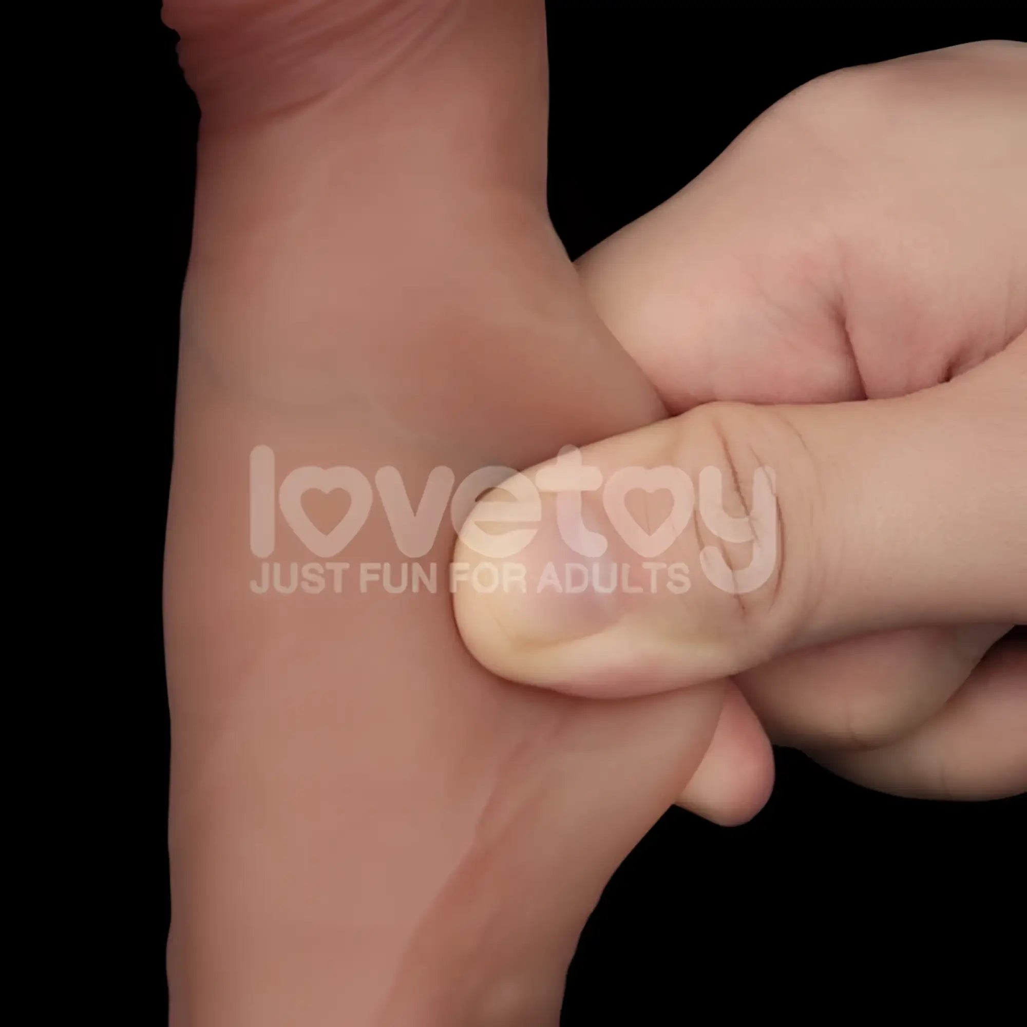 A flesh-toned soft silicone wristband with subtle embossed branding from lovetoy sliding skin pro dual layer silicone dong 7.5in