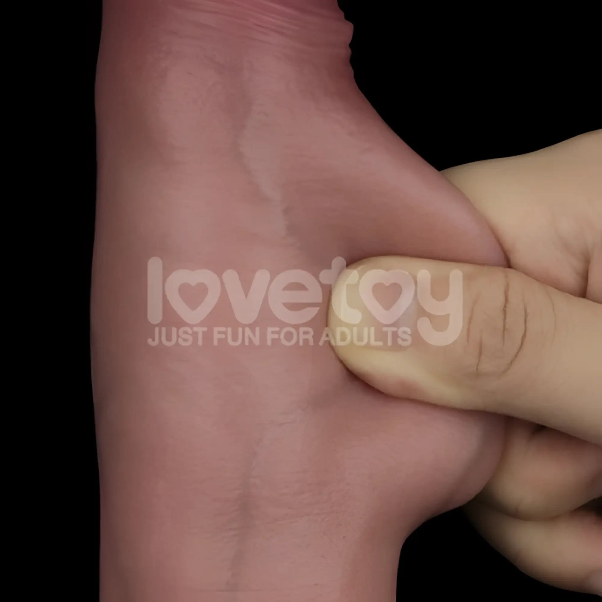 A realistic pink silicone hand with smooth glossy finish and natural texture in the lovetoy sliding skin pro dual layer silicone dong 8.5in