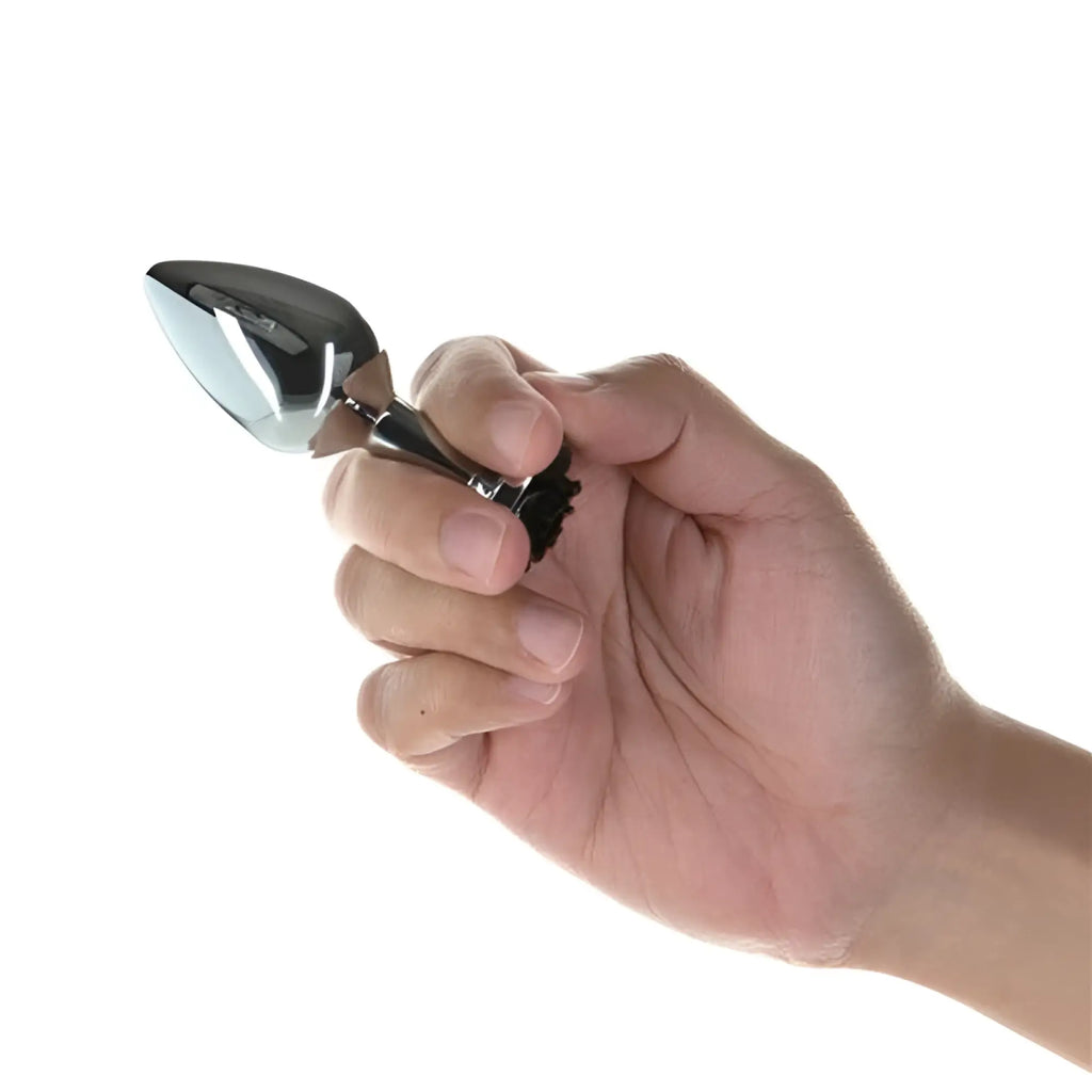 A sleek black and silver 3 inch metal butt plug with polished metallic finish from LUX active black rose